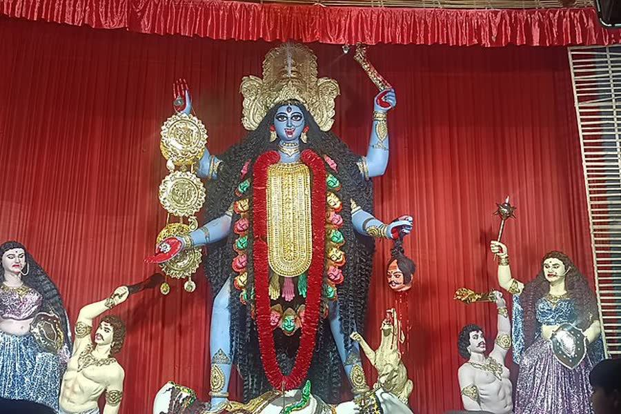 An ornate idol of goddess Kali in a decorated pandal in Kolkata