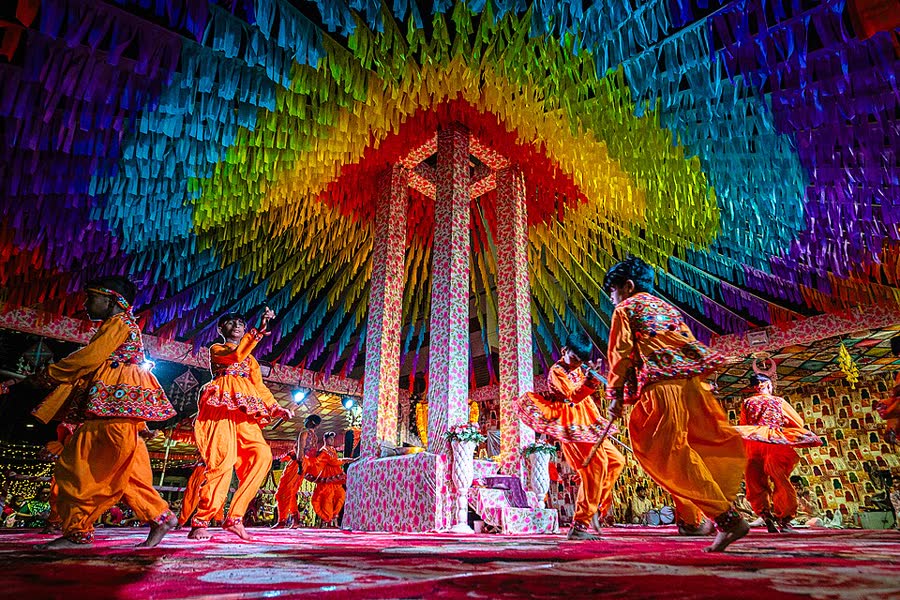 Children in matching colourful traditional costumes perform the Raas dance during Navratri