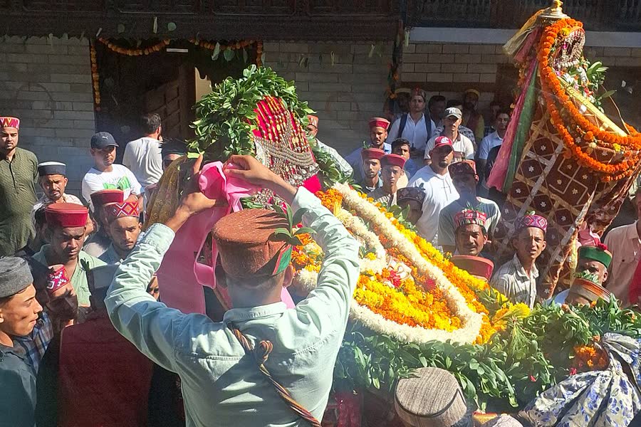 Villagers carry a decorated palanquin of a local deity to meet Lord Raghunath in Kullu
