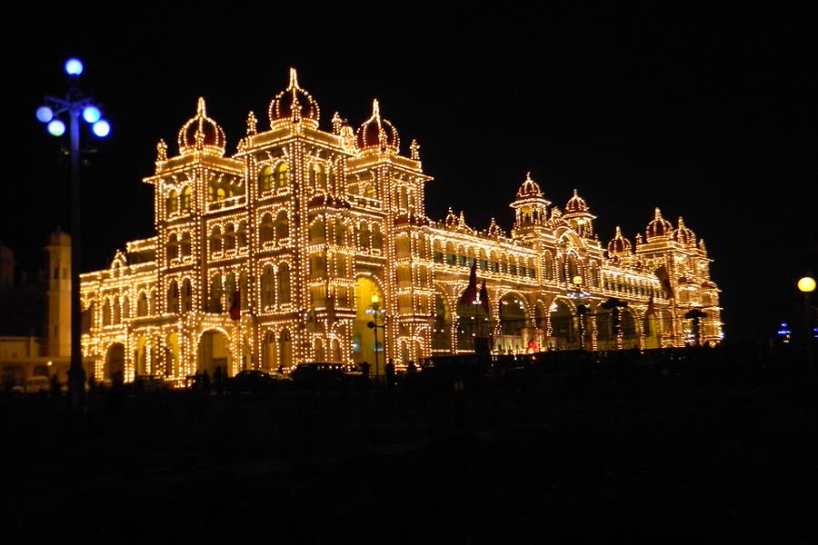Mysore Palace outlined in thousands of glowing light bulbs at night during Dasara
